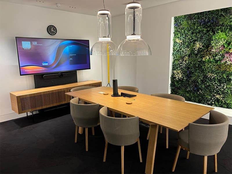 room with a table, chairs, and a television